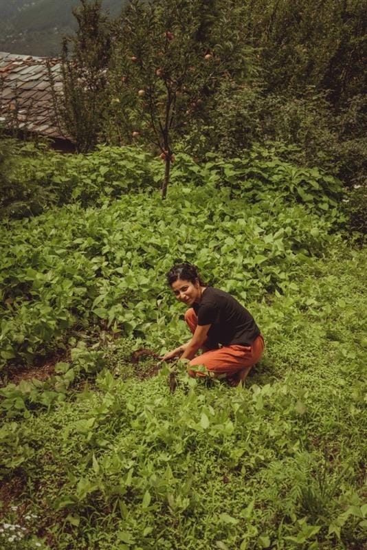 Pragati Shirke tending plants in a mountain garden